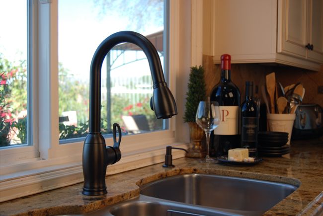 Stainless steel kitchen sink with bronze faucet