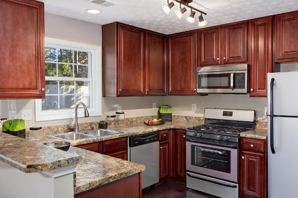 Cherry kitchen cabinets with gray walls